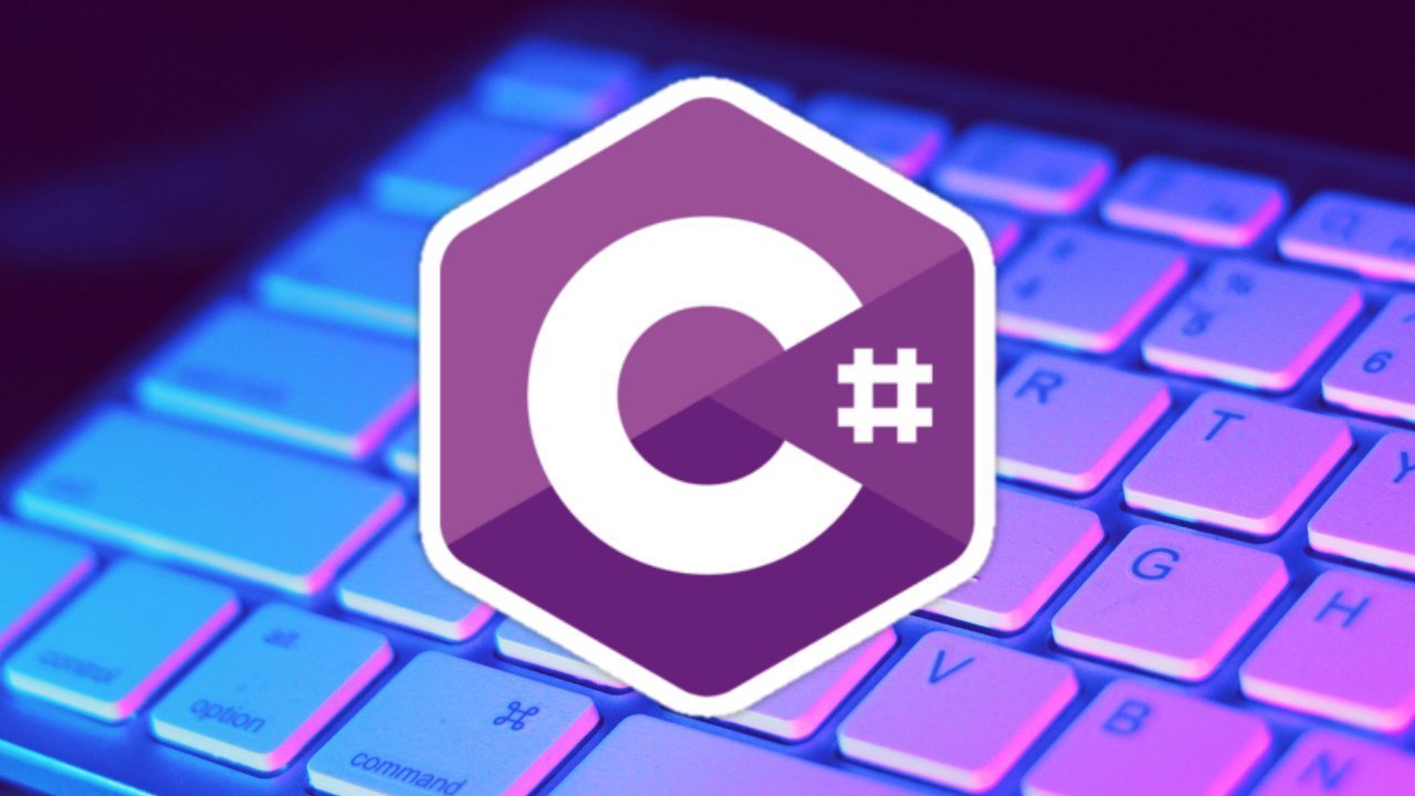 A C# logo sitting atop a computer keyboard